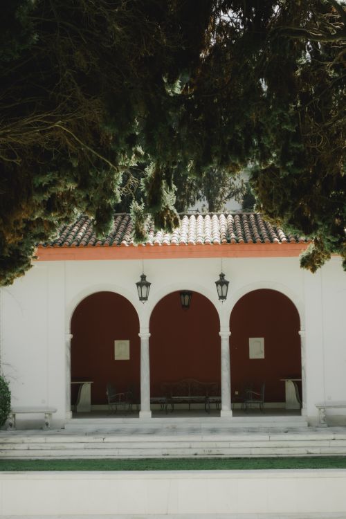 Free Charming Mediterranean architecture featuring elegant arches and lanterns, typical of Greek style. Stock Photo