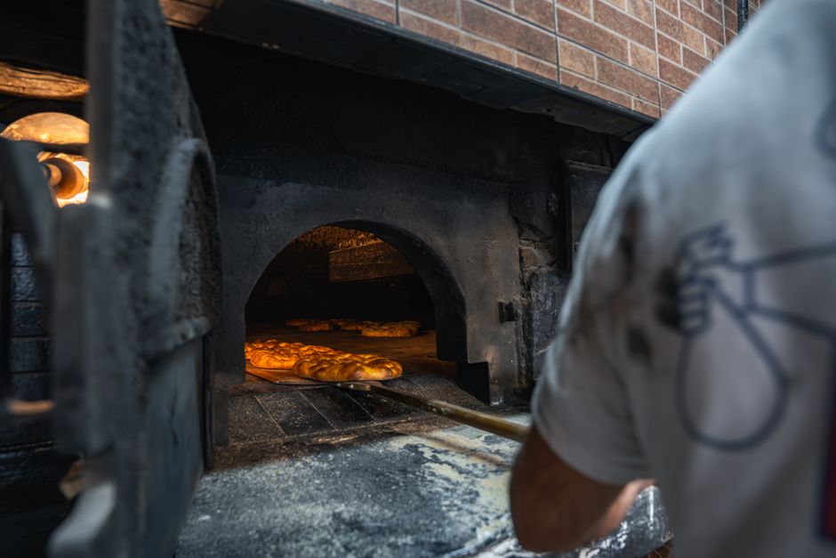 A fresh burek (meat or cheese pie) displayed in a traditional pekara (bakery) in Podgorica, Montenegro.