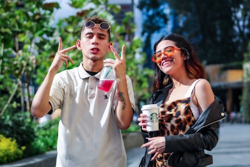 Man and Woman Holding Starbucks Cup