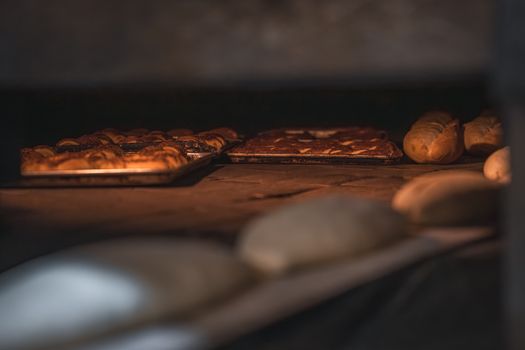 Close-up view of freshly baked bread and pastries in an artisan bakery's oven.