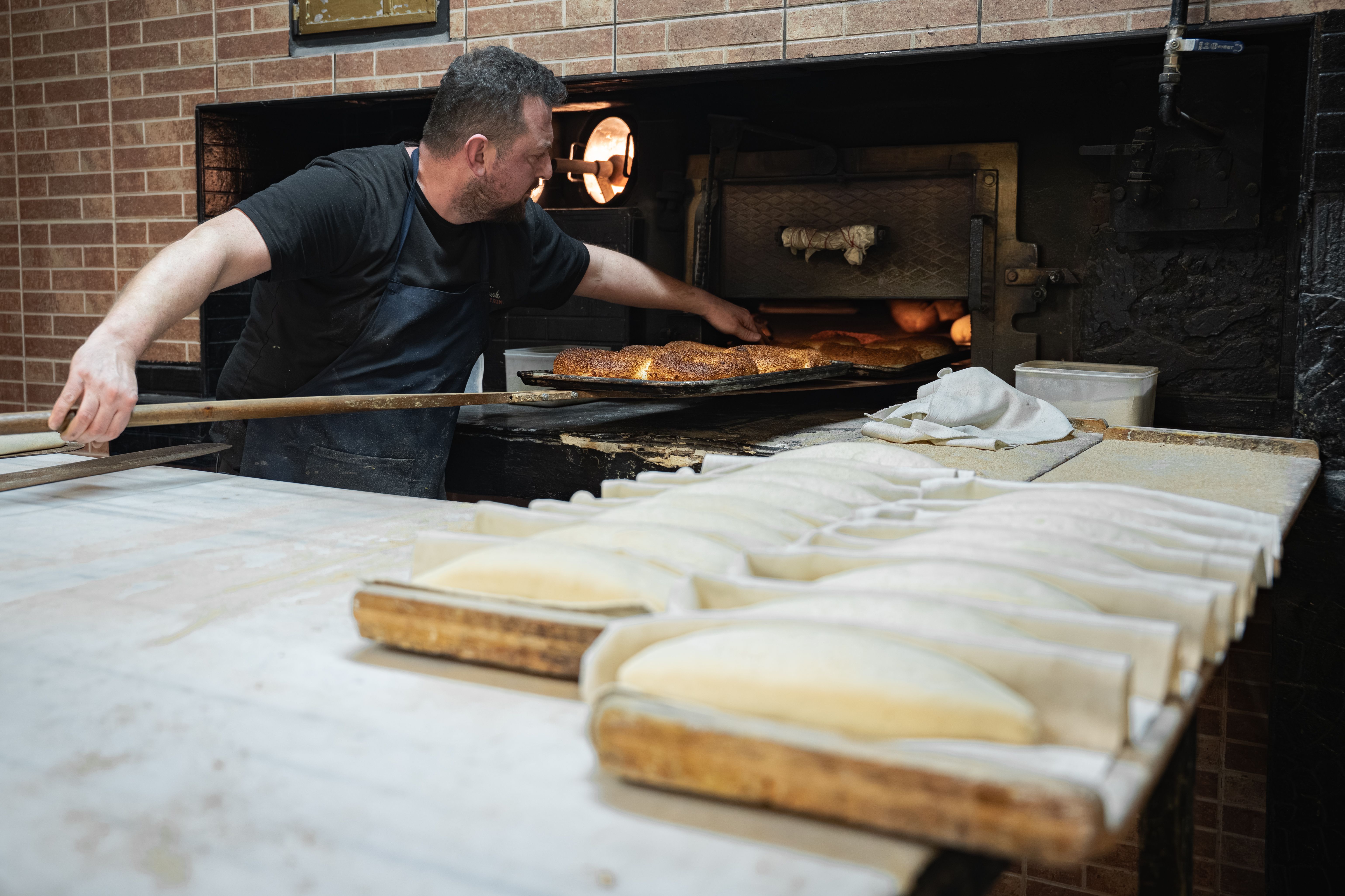 A freshly baked, golden-brown burek with cheese from a traditional Serbian pekara.