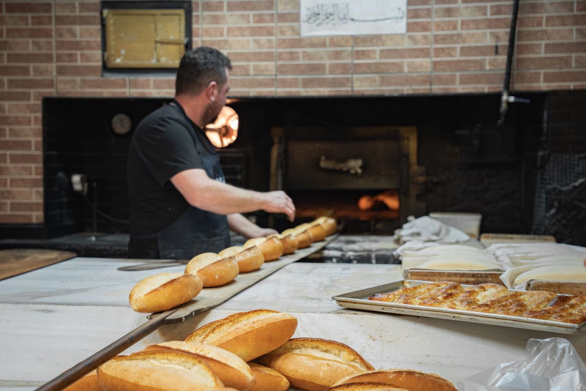 Traditional Baker at Work in Rustic Bakery · Free Stock Photo