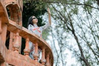 Elegant Woman on Vintage Brick Balcony Outdoors