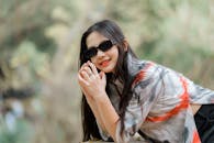 Stylish Young Woman Posing Outdoors in Sunglasses