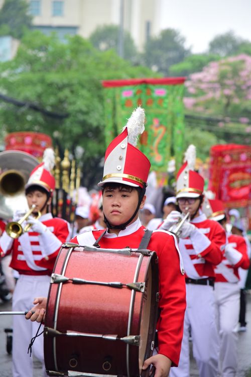 Free Energetic marching band performing with vibrant uniforms in an outdoor parade. Stock Photo