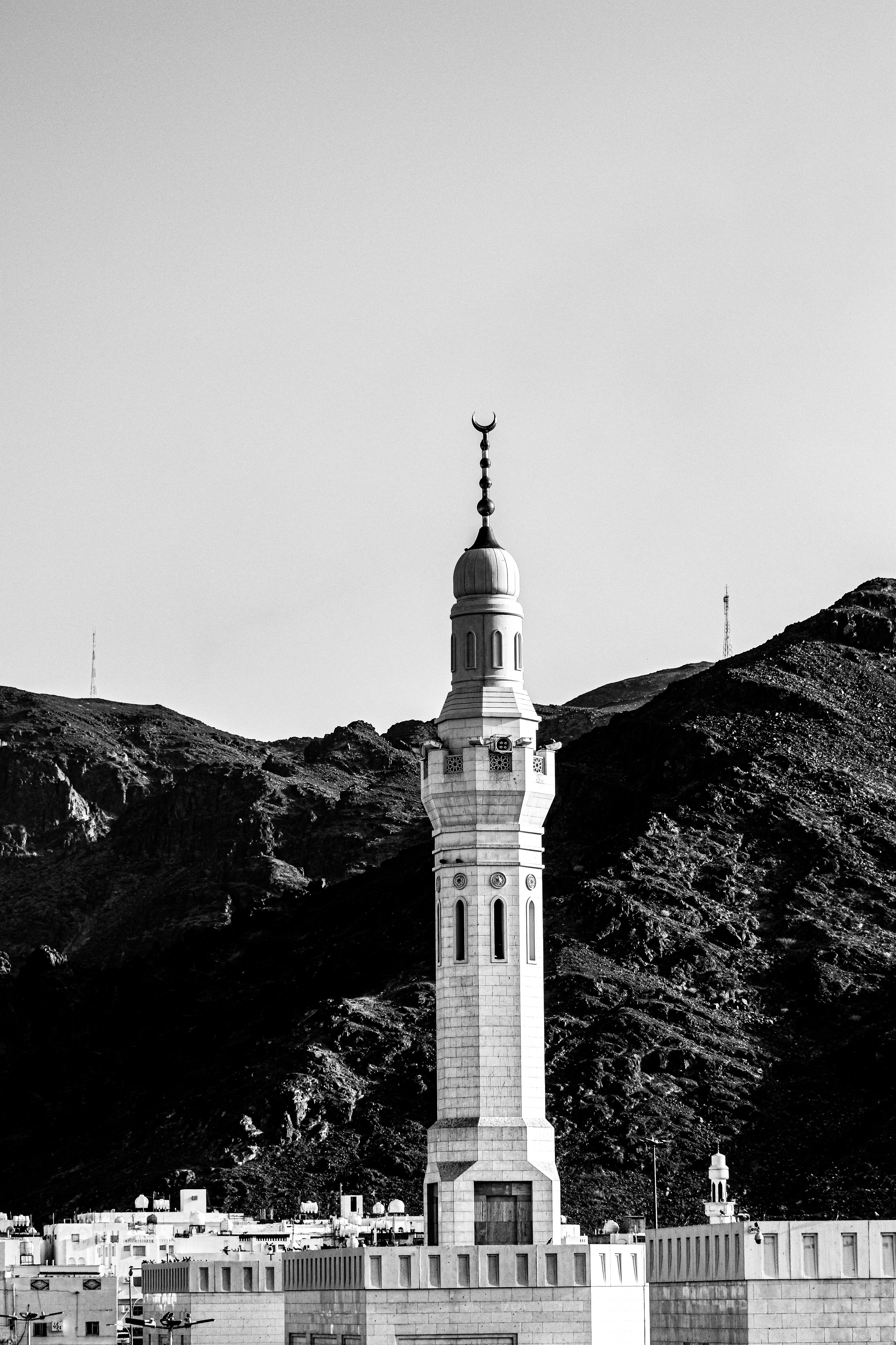 Majestic Mosque Minaret against Mountain Backdrop · Free Stock Photo