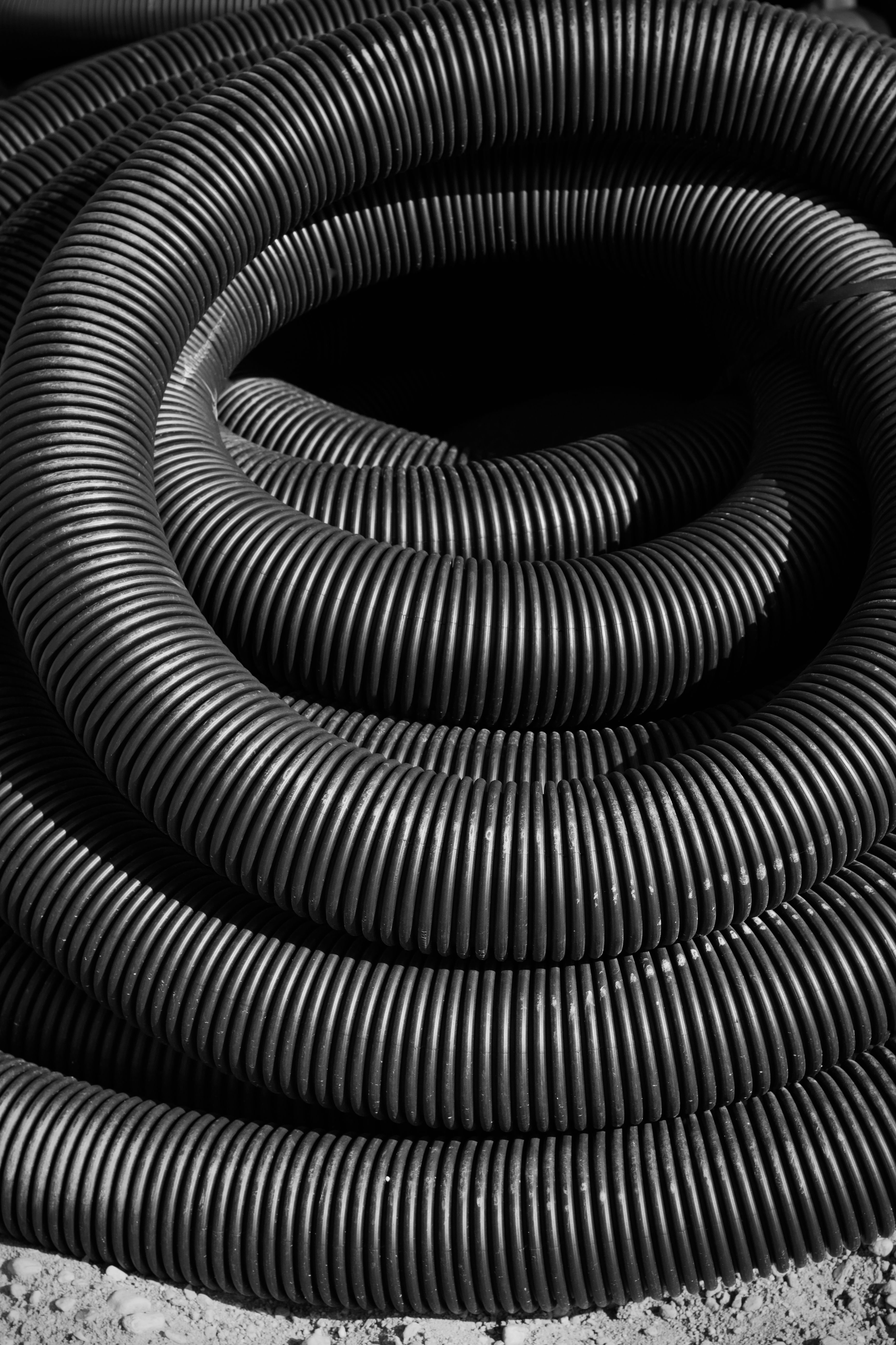 Large stacks of steel wire coils at an industrial site