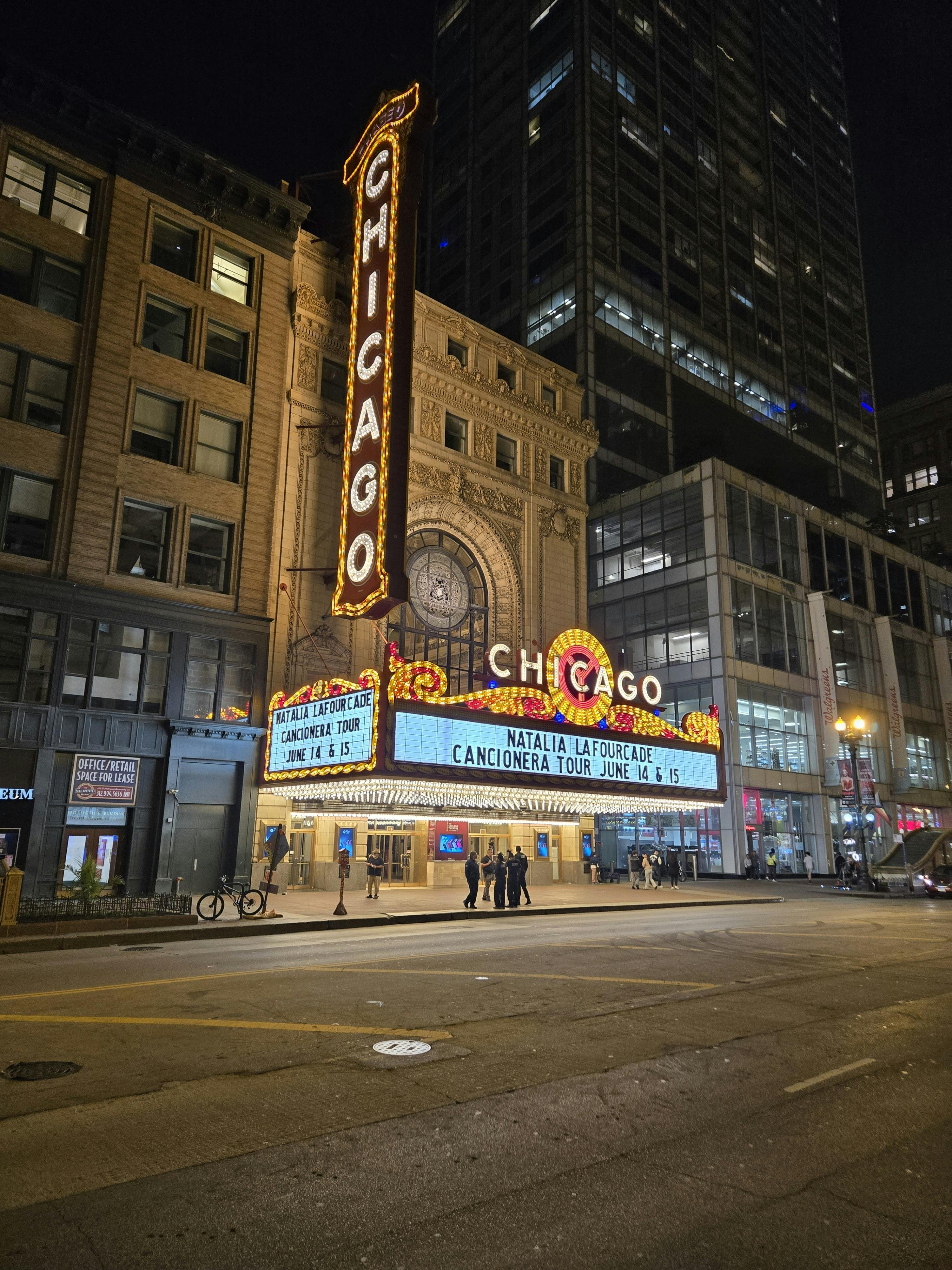 Illuminated Chicago Theater at night with marquee lights.