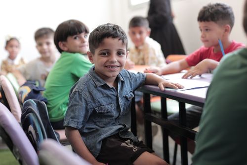 Free A group of cheerful children in a classroom in Gaza, actively participating in class activities. Stock Photo