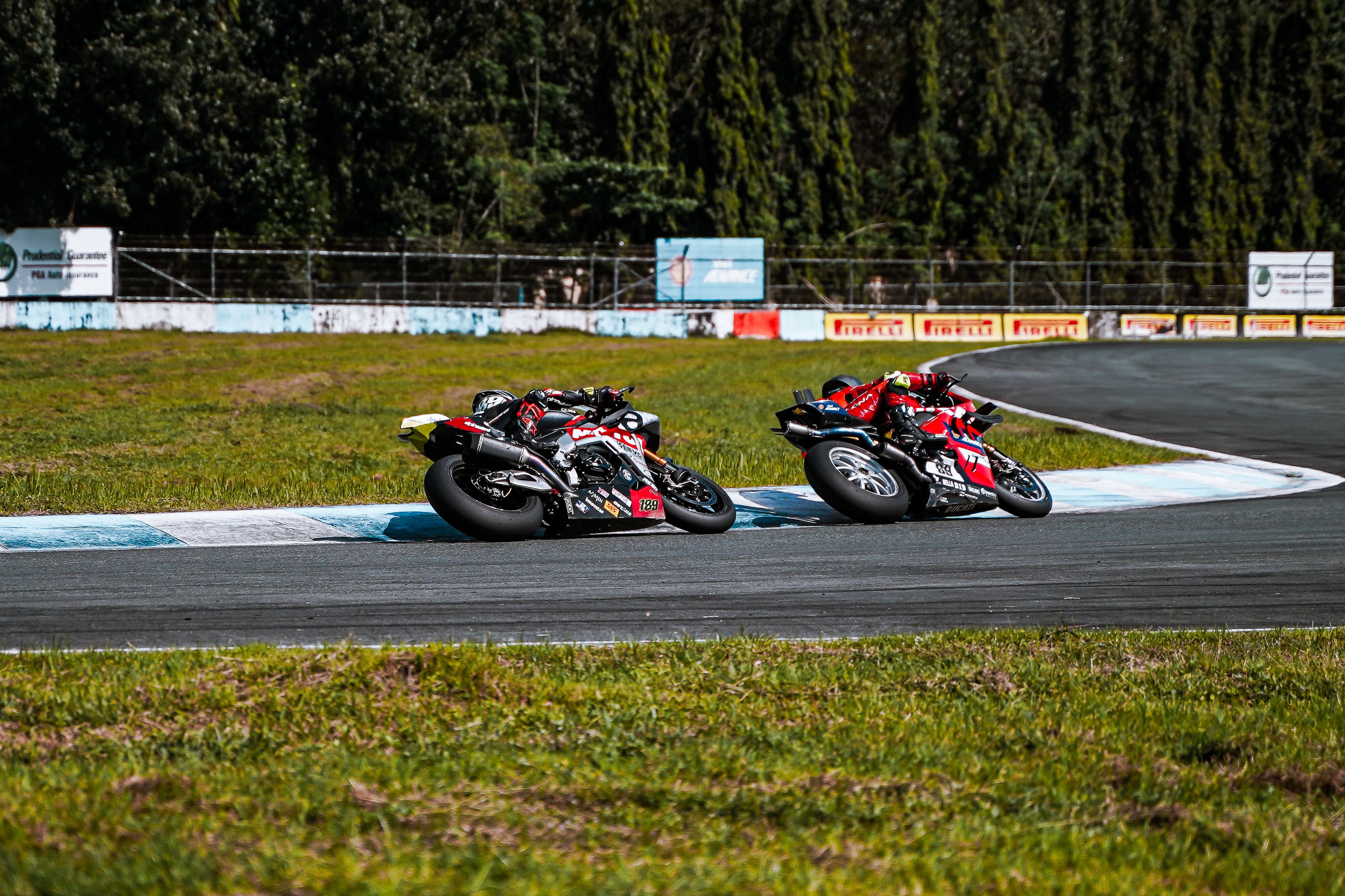 High-Speed Motorcycle Race on Curving Track · Free Stock Photo