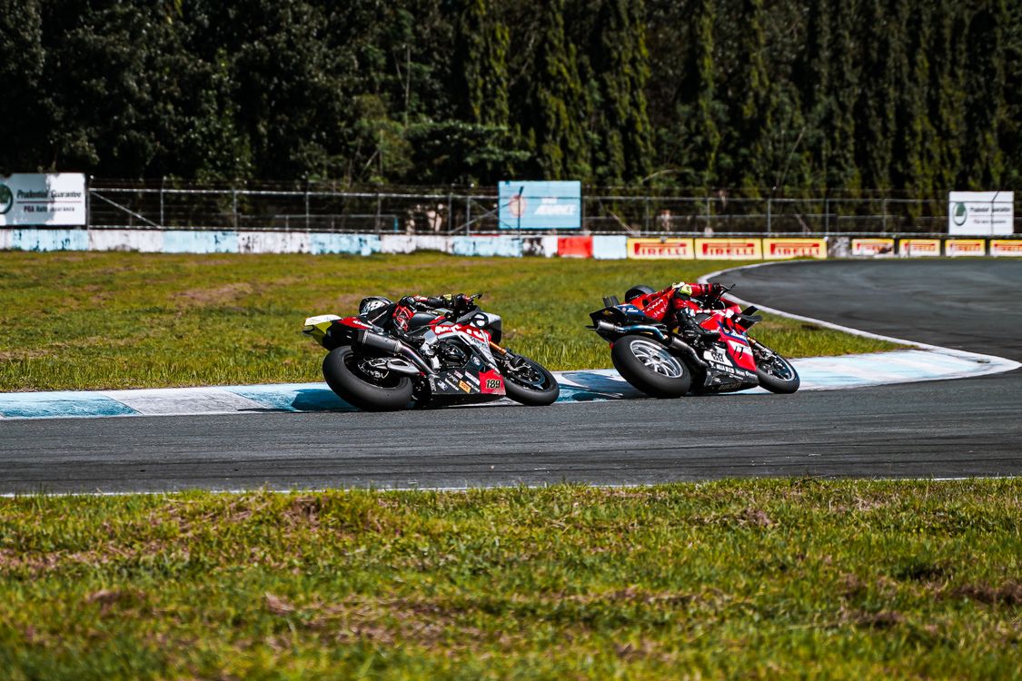 High-Speed Motorcycle Race on Curving Track · Free Stock Photo