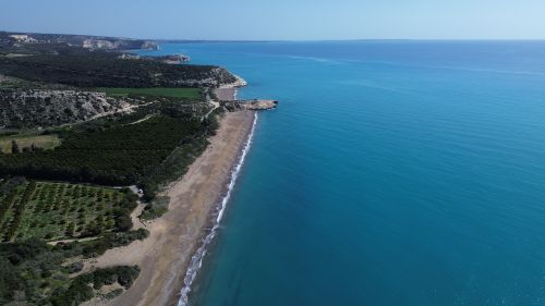 Free Stunning aerial shot of Pegeia beach and cliffs in Cyprus, showcasing crystal-clear waters. Stock Photo