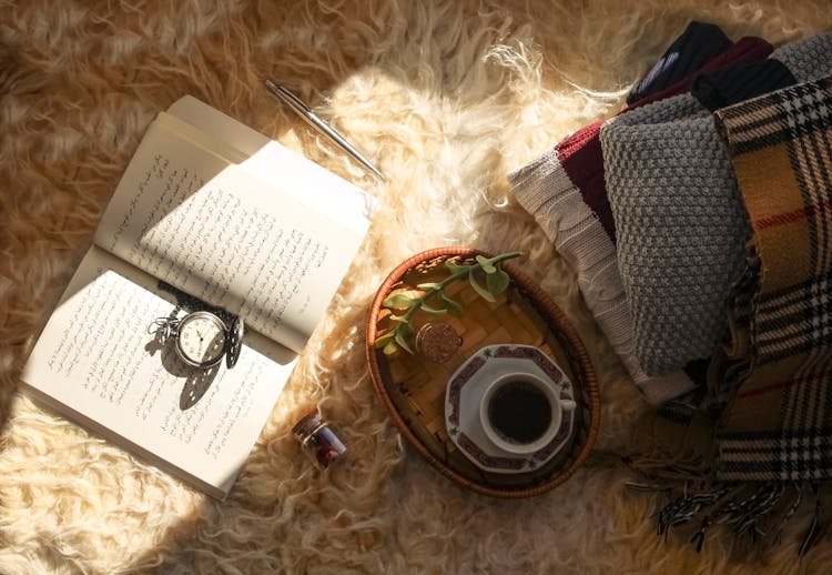 Diary And Coffee On Hairy Carpet