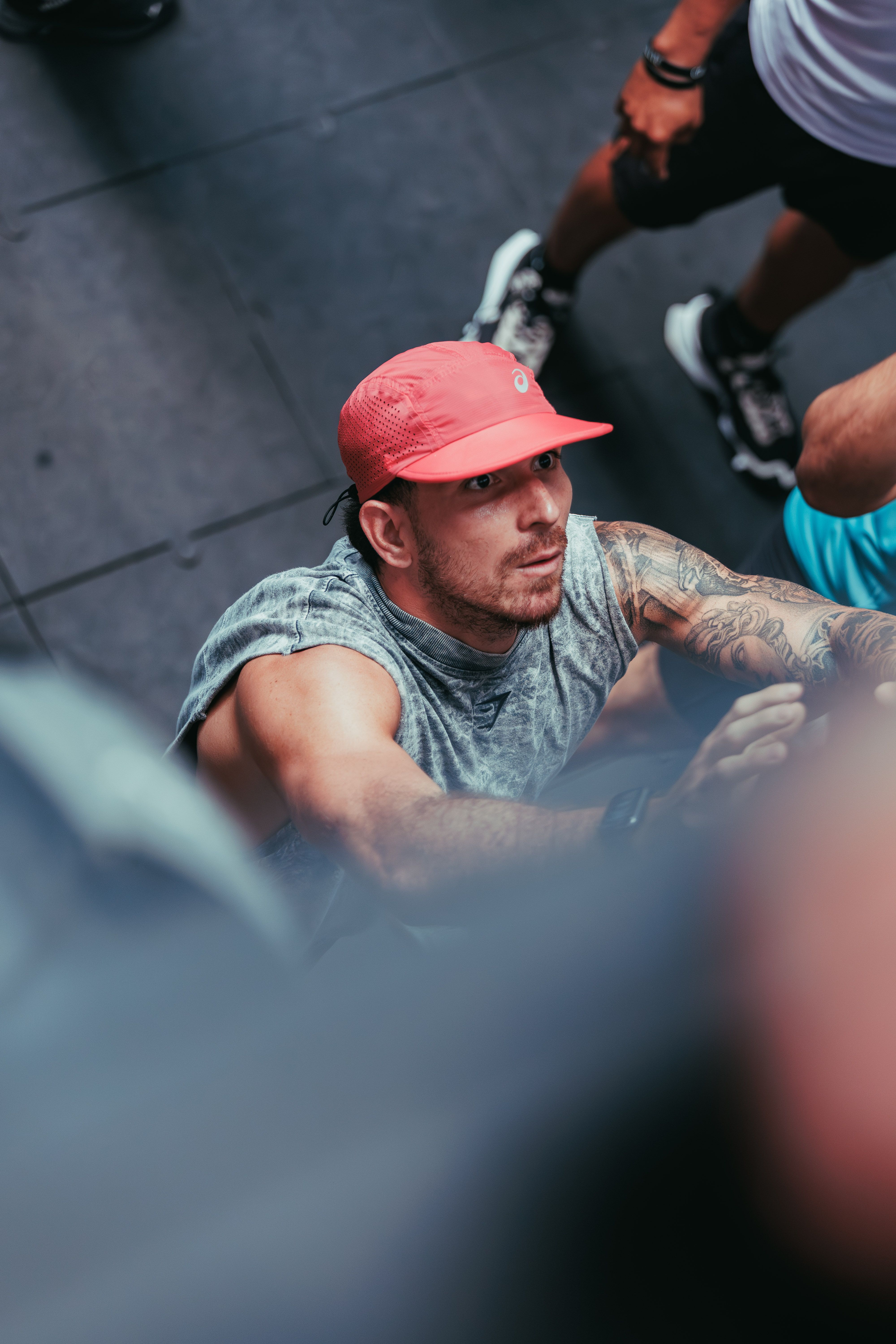 Man in Red Cap and Tattoo at Gym · Free Stock Photo