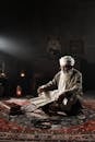 Elderly Man Reading Religious Scripture Indoors
