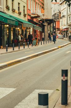 A charming European street lined with outdoor cafes and colorful buildings, perfect for a leisurely stroll.