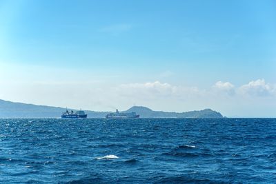 Two ferries crossing open water near distant islands — photo by Nothing Ahead on Pexels