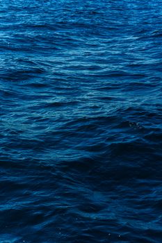 Captivating view of deep blue ocean waves under the bright daylight, showcasing natural beauty.