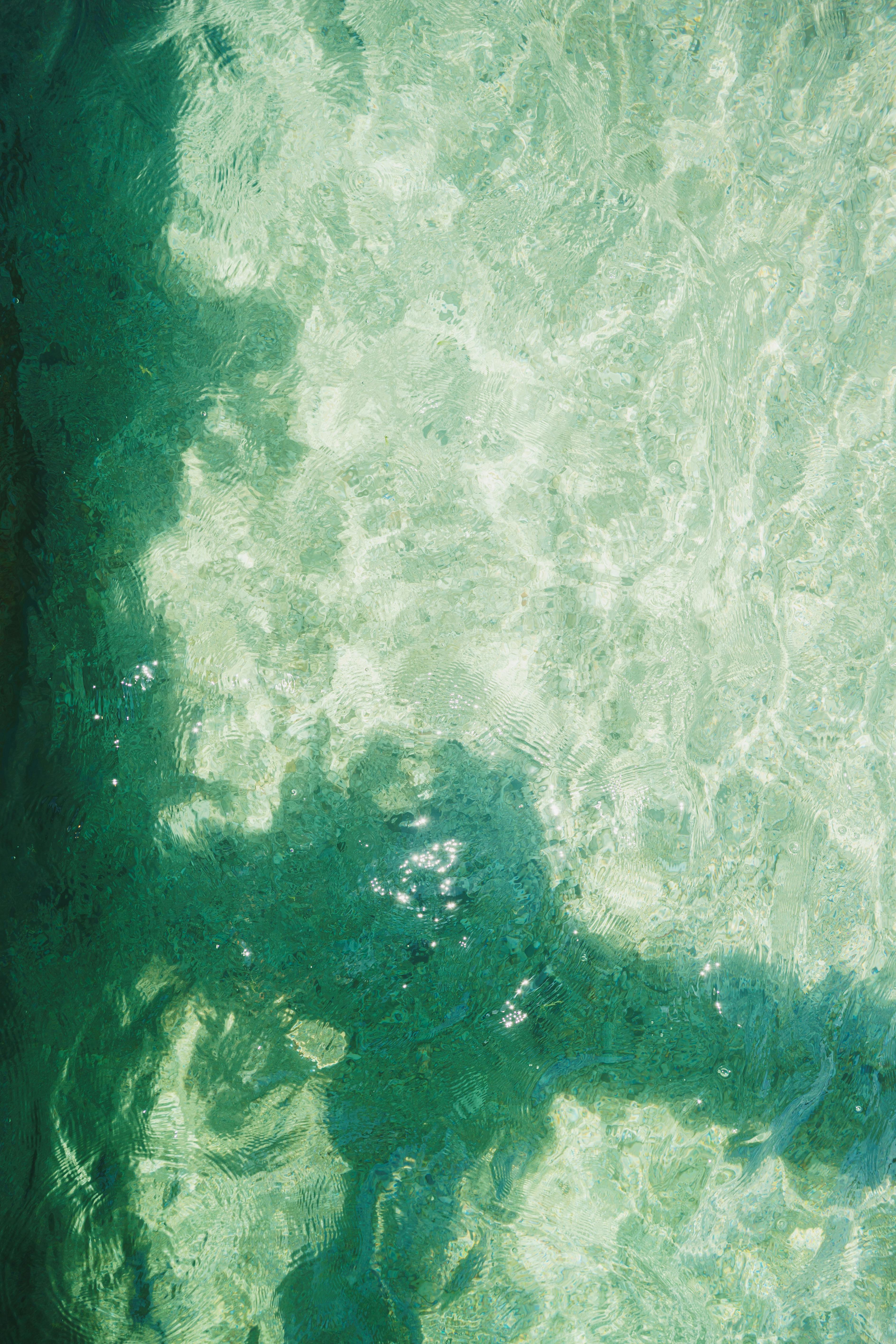 Free A tranquil scene of sunlight and shadow patterns on clear water, creating a calming aesthetic. Stock Photo