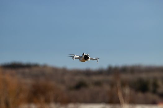 A close-up shot of a drone flying outdoors in Jönköping, Sweden, against a clear blue sky.