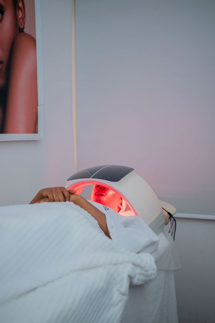 Woman receiving red light therapy on her face
