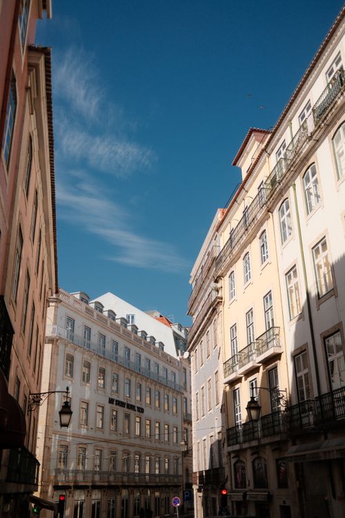 Free Historic European architecture in Lisbon under a clear blue sky, showcasing classical building facades. Stock Photo