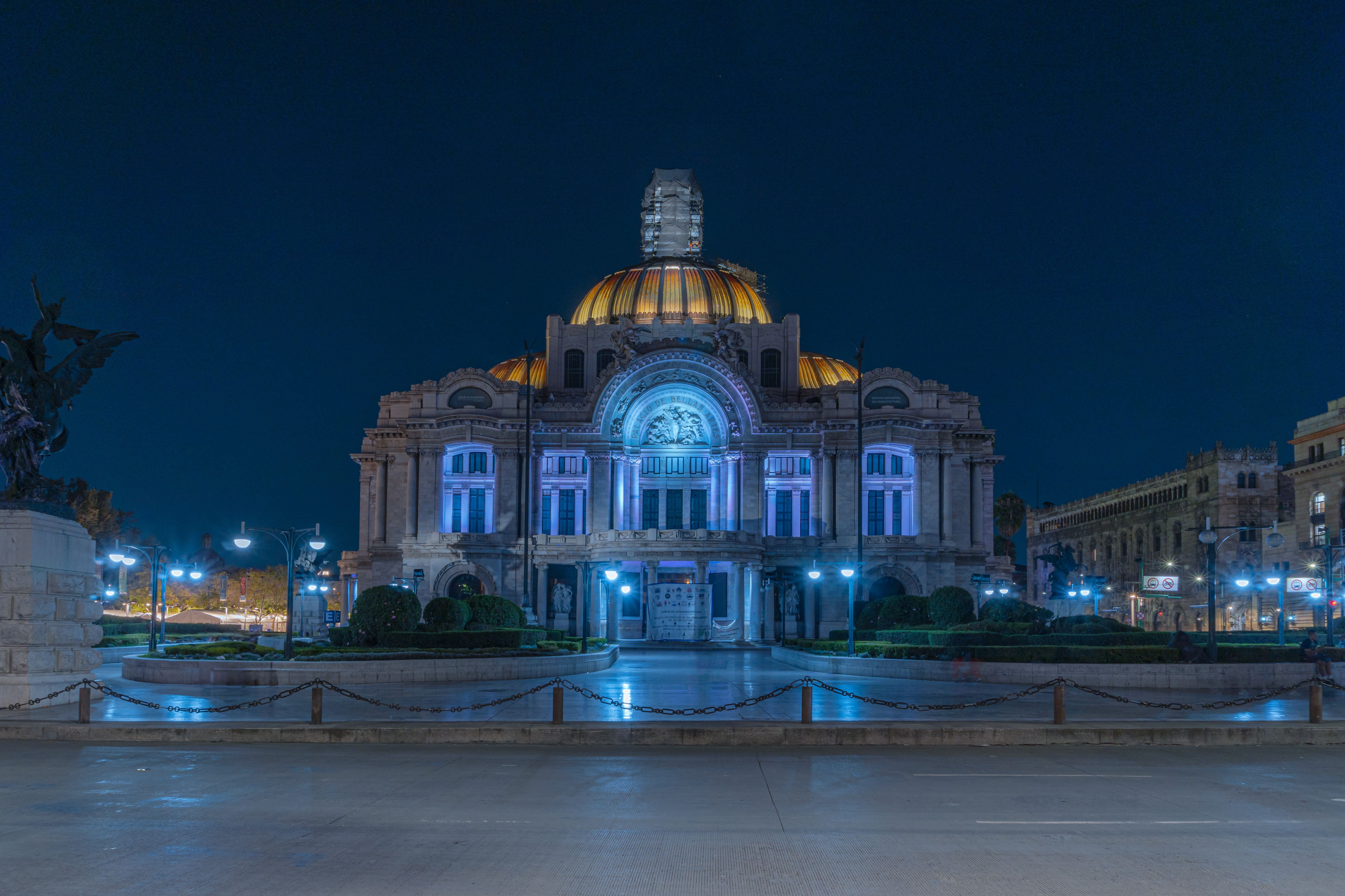 Stunning night view of the illuminated Palacio de Bellas Artes in Mexico City, showcasing its architectural beauty.