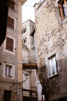 Charming alleyway view of historic stone buildings in Anagni, Lazio, Italy.