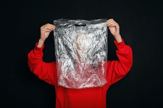 Person Holding A Plastic Bag