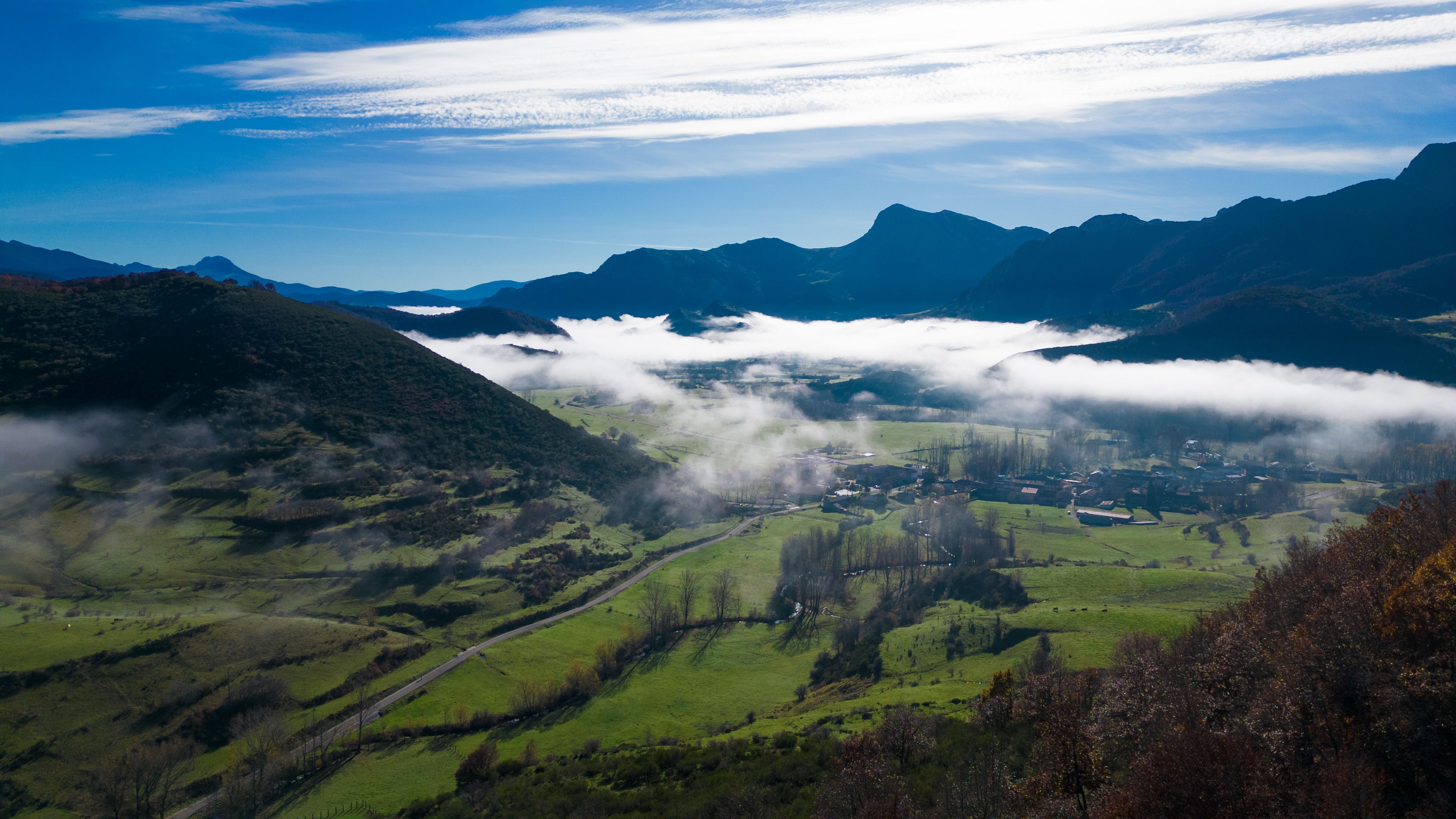 Explore the serene landscape of Riaño, Spain, featuring lush valleys and mountain scenery.