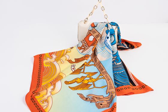Silk scarf draped over a handbag — photo by Dau Photograph on Pexels