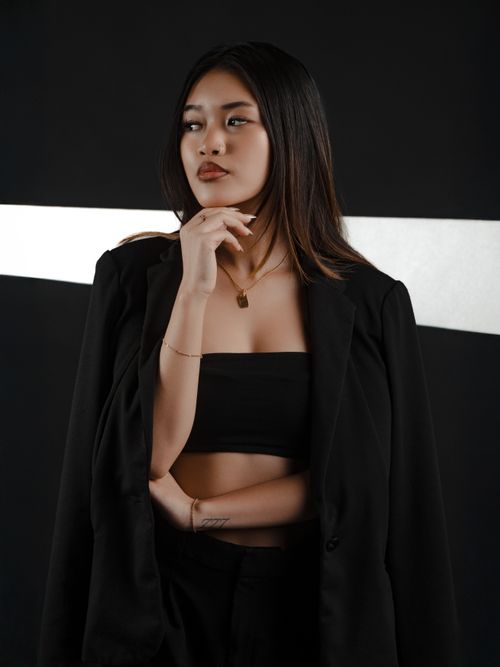 Free Chic woman in black attire posing against a studio backdrop in Las Vegas. Stock Photo