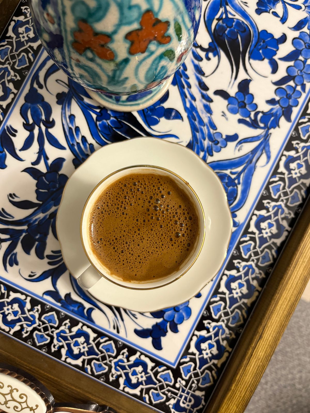 Blue and white patterned ceramic tray with a cup of coffee