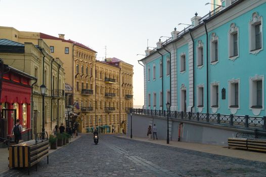 Explore the historical charm of Andriivskyi Descent in Kyiv with colorful architecture at dusk.