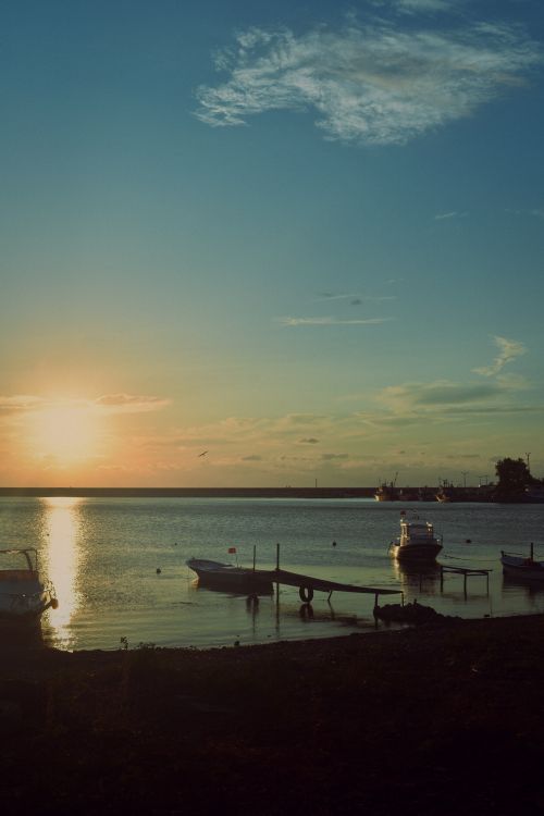 Free Peaceful sunset over Cide Harbor with boats gently floating on calm water. Stock Photo