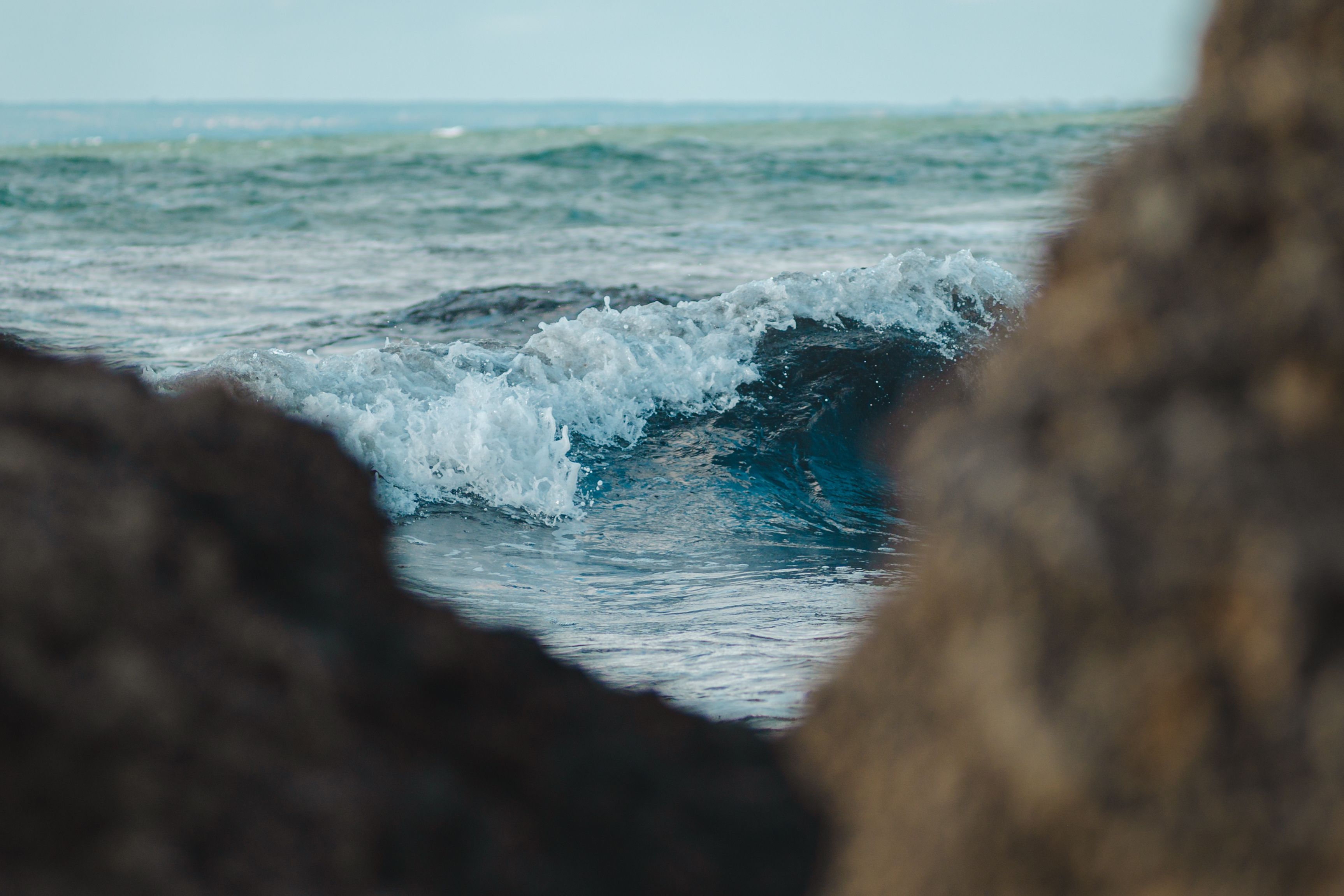 Dynamic Ocean Wave Crashing Between Coastal Rocks · Free Stock Photo