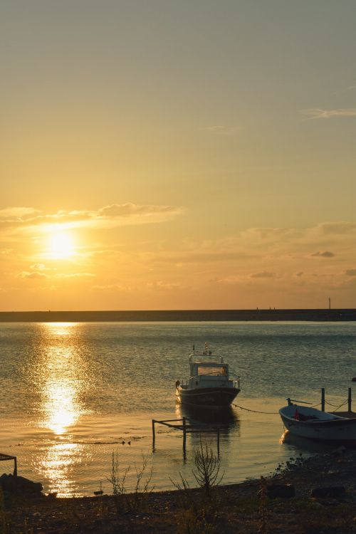 Free Tranquil sunset at Cide harbor in Türkiye with boats gently floating on calm waters. Stock Photo