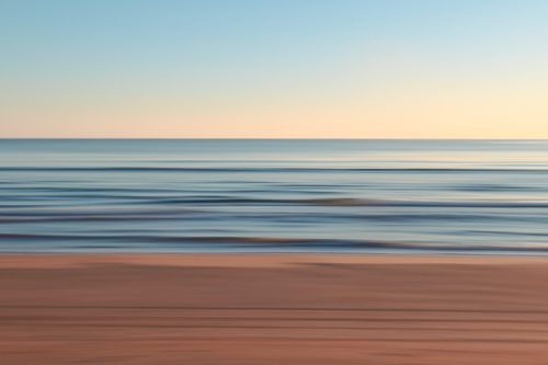 Free Blurry long exposure of a tranquil ocean at dusk, creating a serene and calming atmosphere. Stock Photo