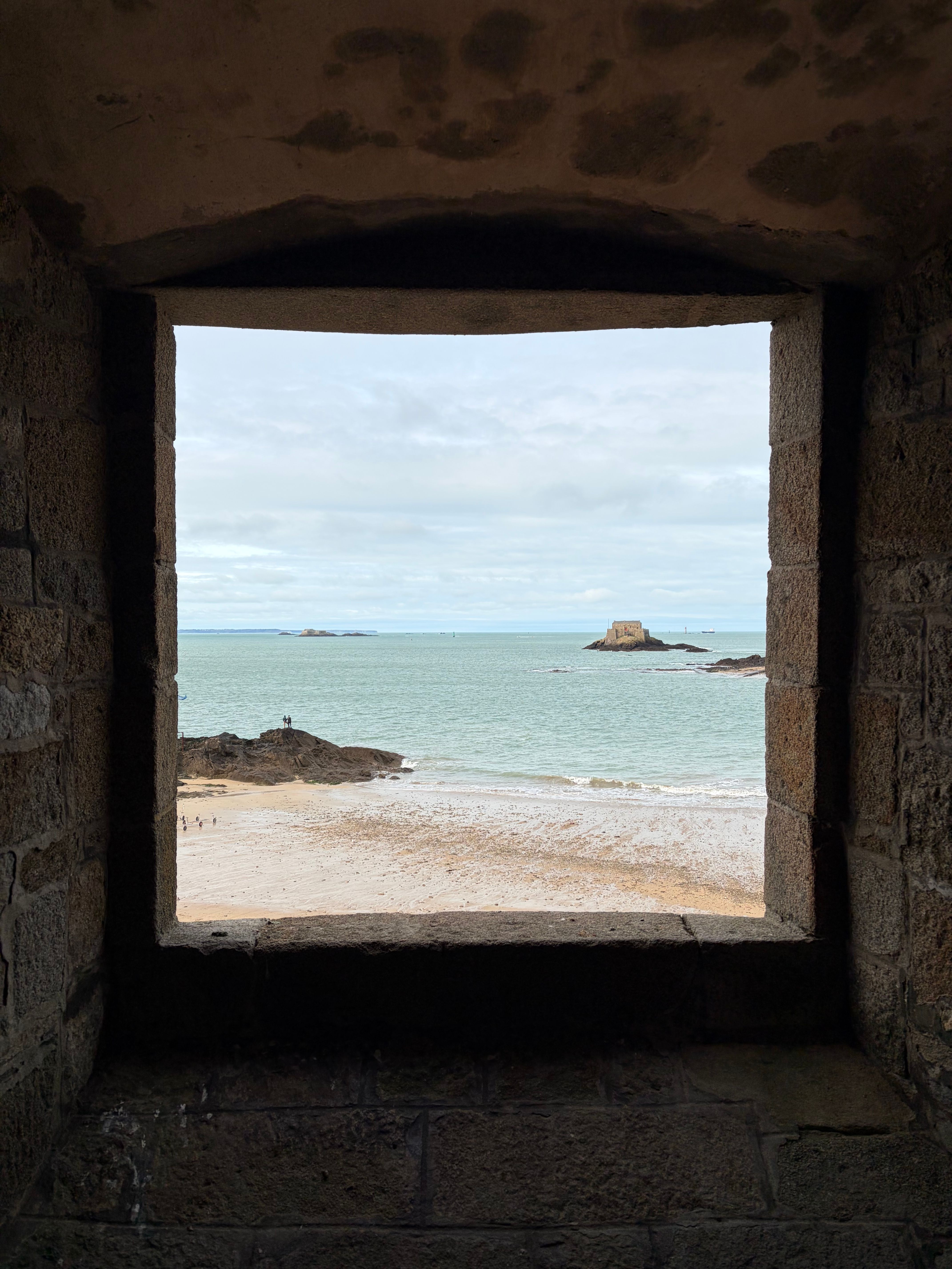 Scenic Beach View through Stone Window Frame · Free Stock Photo