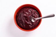A vibrant açaí bowl with a silver spoon, showcasing a healthy tropical superfood.