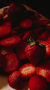 Vivid, fresh strawberries captured in dramatic lighting, emphasizing texture.