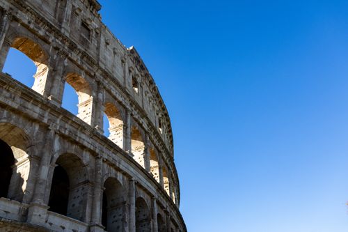 Free Stunning perspective of the Colosseum in Rome with a bright clear blue sky backdrop. Stock Photo