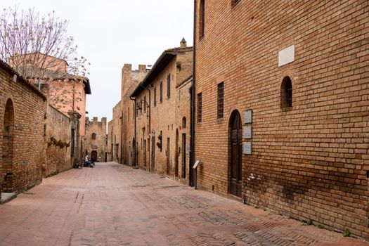 Explore the historic brick-lined streets of Certaldo in Tuscany, showcasing medieval architecture.