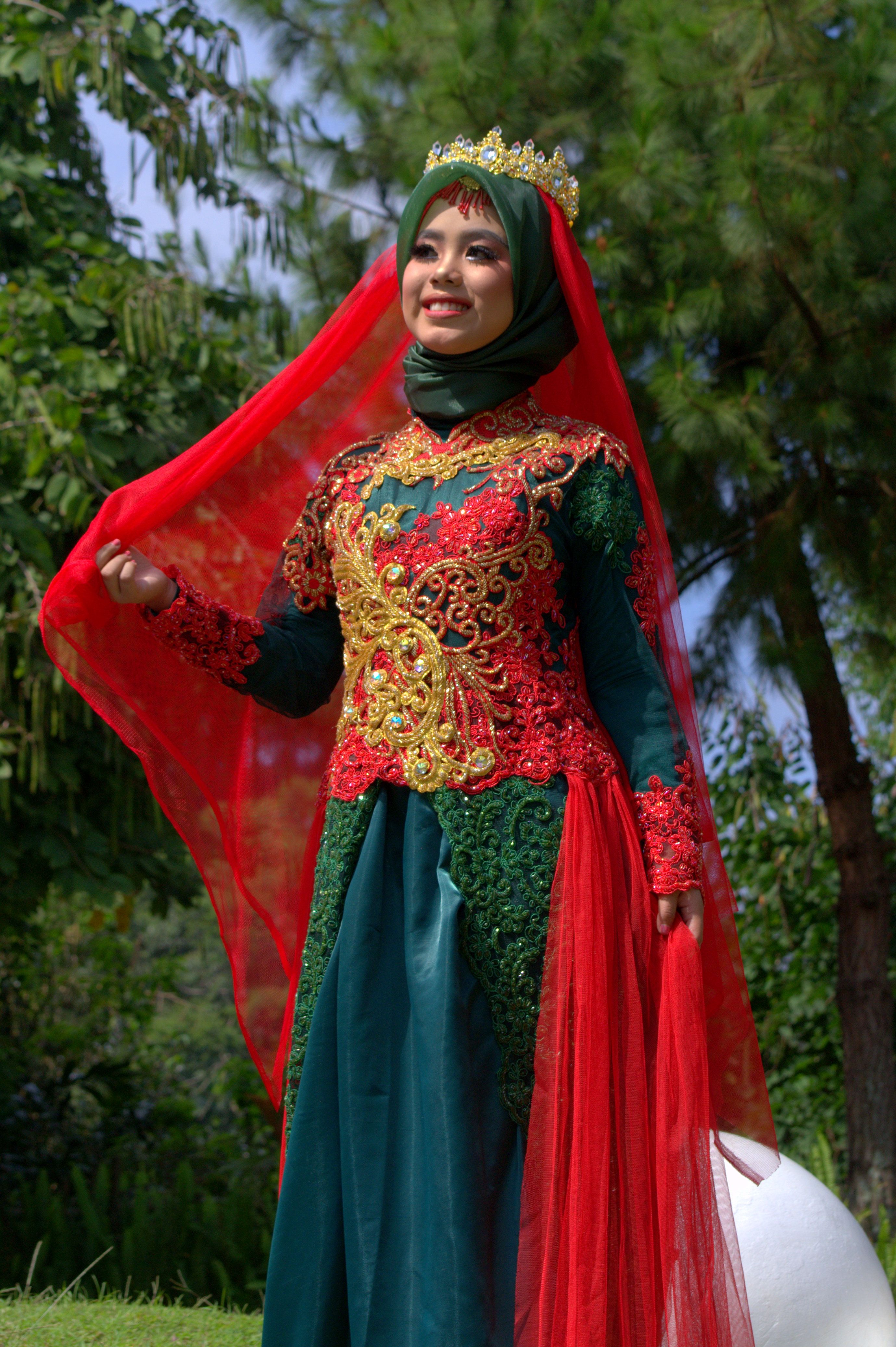 Elegant Woman in Traditional Indonesian Attire Outdoors