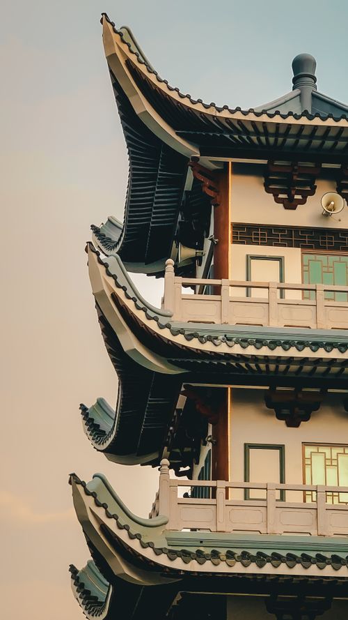 Free Close-up of a traditional Asian pagoda with intricate roof detail during sunset. Stock Photo