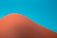 Abstract Sand Dune Against Clear Blue Sky