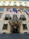 Festive Entrance of Italian Building with Flags