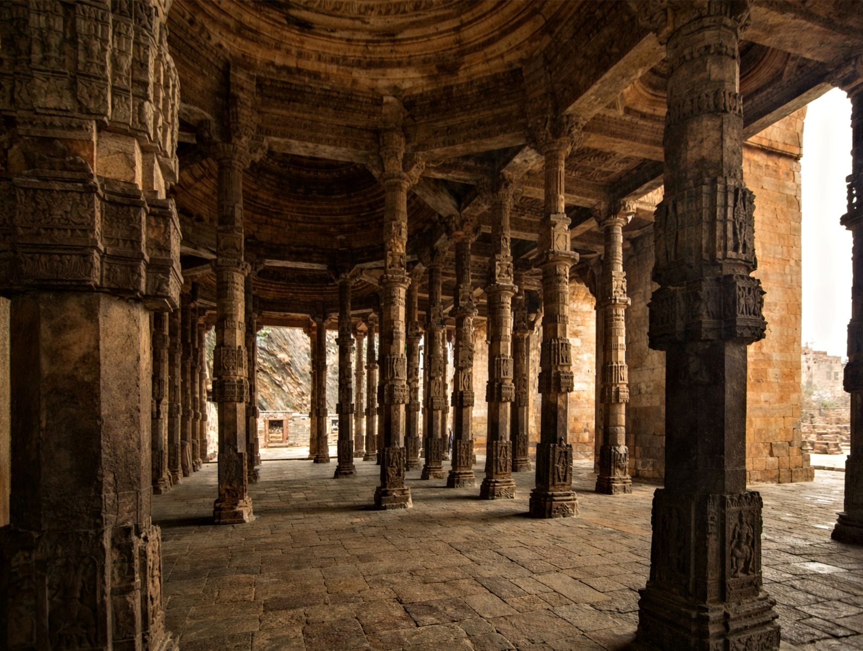 Stone columns in a historic structure in Ajmer, showcasing intricate Islamic architecture.