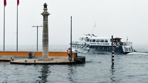 Free A serene lakeside view featuring a dock and a boat in Italy, perfect for travel enthusiasts. Stock Photo