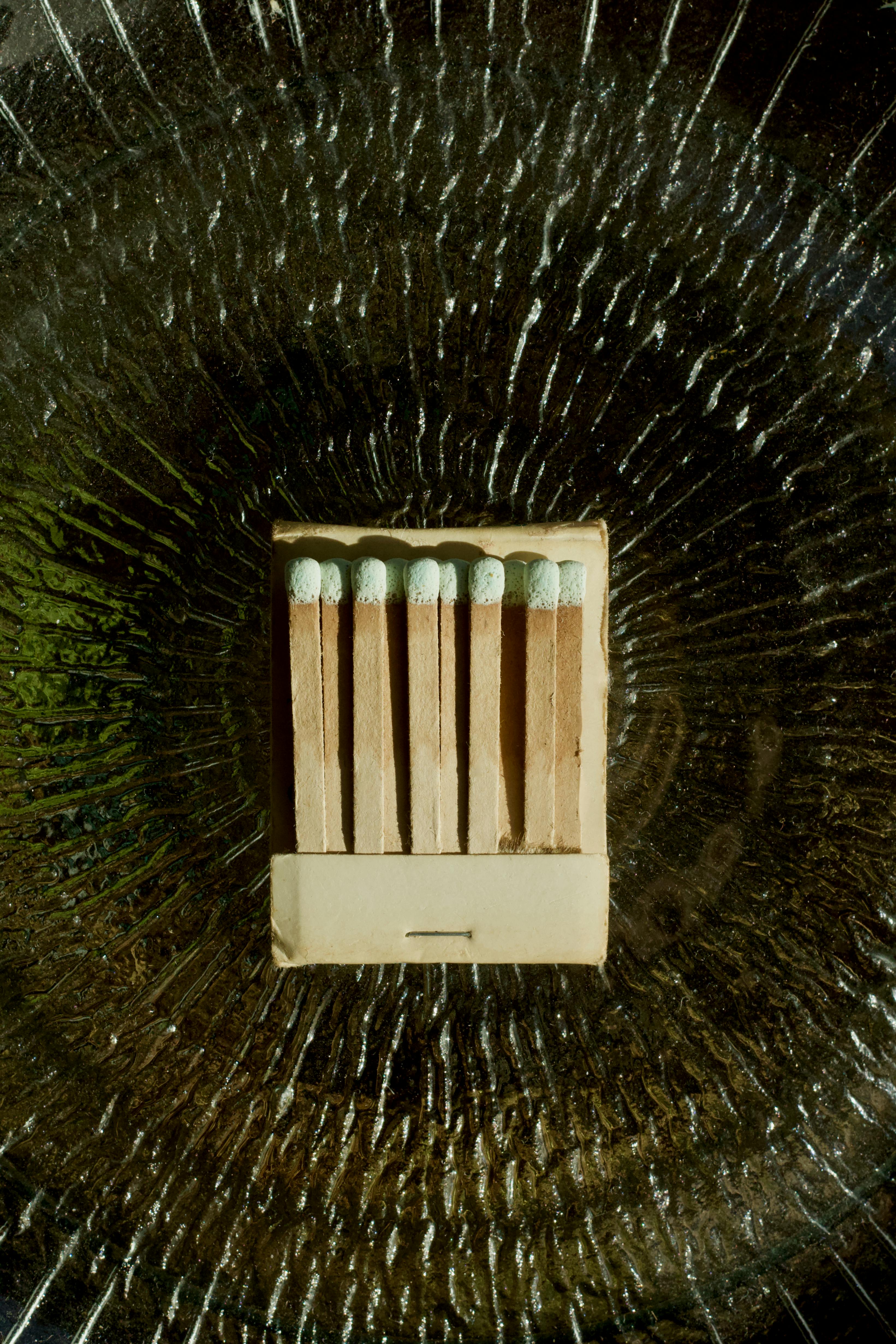 Free Close-up of matchsticks creatively arranged on a textured surface. Artistic and conceptual look. Stock Photo
